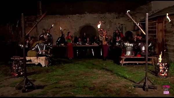A medieval group sex party happens outside of the castle under the night sky