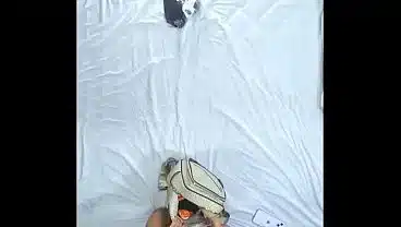 Ceiling view. Slim tiny model puts on sexy red lingerie